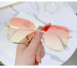Detail of rimless sunglasses featuring gradient lenses and slim gold metal temples