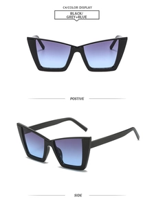 Detail of cat eye sunglasses with black frames and grey to blue gradient lenses