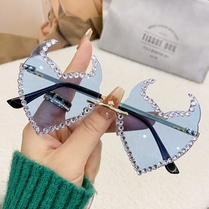 Y2K rimless flame sunglasses with blue lenses and white rhinestones on golden frame