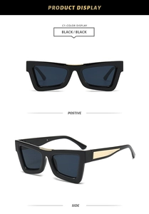 Detail of retro cat-eye sunglasses with thick black frame and golden wavy metal accents