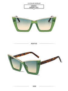 Detail of cat eye sunglasses with green frames, gold metal trim, and tortoiseshell temples