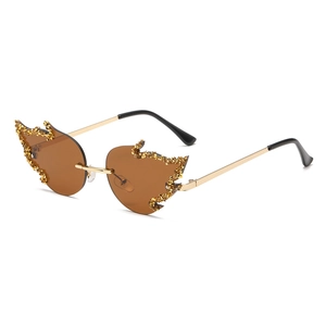 Frameless flame shaped sunglasses with golden rhinestones and brown lenses for party