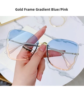 Detail of rimless sunglasses with gold metal temples and blue-pink gradient lenses