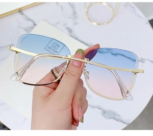 Detail of rimless square sunglasses with blue-pink gradient lenses and gold metal temples