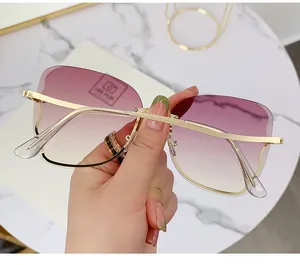 Detail of rimless gradient purple sunglasses with elegant gold metal temples and hinges