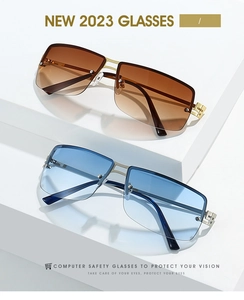 Detail of rimless oval sunglasses with gradient lenses and gold metal frame design