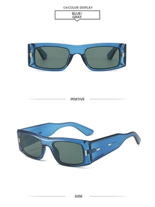 Detail view of rectangular blue transparent sunglasses with grey lenses and gold accents