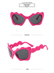 Front and side views of rose red wavy irregular sunglasses with black lenses