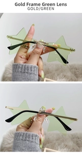 Close-up of gold metal temples and star-shaped green lenses of rimless sunglasses