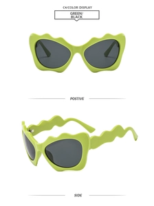 Detail of lime green irregular wavy frame sunglasses with dark grey UV protective lenses