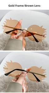 Détail de lunettes de soleil sans monture en forme de flamme avec branches dorées