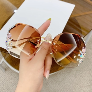 Luxury rimless oversized sunglasses with gradient brown lenses and crystal rhinestone accents