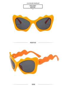Front and side views of orange wavy cat eye sunglasses with grey lenses