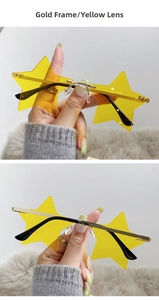 Detail of star-shaped rimless sunglasses featuring gold frame and yellow lenses