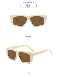 Detail view of beige cat-eye sunglasses with tea lenses and silver metal rivet accents