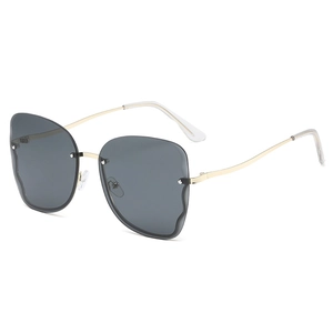 Fashionable rimless butterfly sunglasses with dark grey lenses and gold metal temples