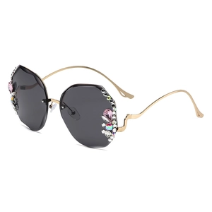 Luxurious rimless polygonal sunglasses with crystals and golden wavy metal temples
