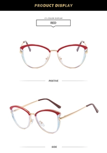 Detail view of red and gold cat-eye glasses frame with sleek metallic accents