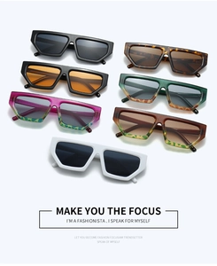 Flat lay collection of trendy geometric diamond-shaped sunglasses in seven diverse colors