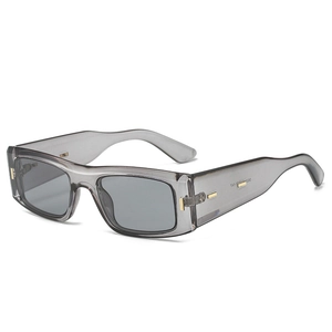 Modern rectangular sunglasses with grey translucent frames and gold metal accents