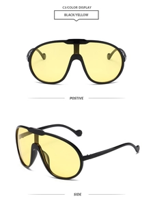 Detailed front and side views of oversized matte black sunglasses with yellow lenses