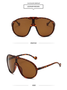 Detail view of leopard print oversized pilot sunglasses with brown tinted lenses