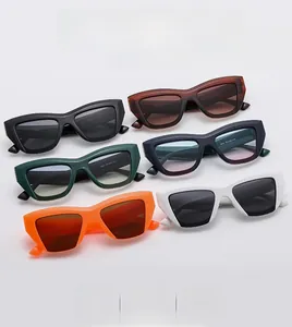 Flat lay of retro chunky cat eye sunglasses in various colors on white background