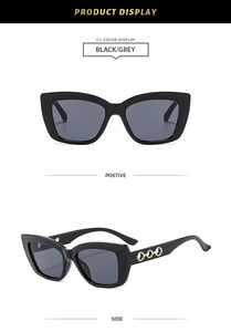 Detail of cat eye sunglasses with thick black frames and gold hollow circle temple accents