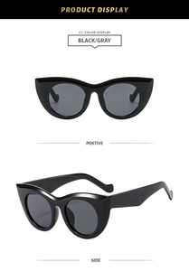 Front and side views of black cat-eye sunglasses with dark gray lenses in high polish