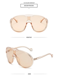 Detail view of brown one-piece oversized sunglasses with seamless wrap design