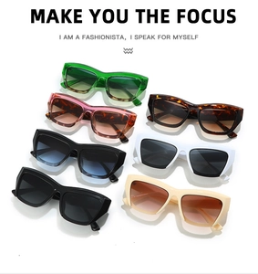 Flat lay of trendy cat eye sunglasses in multiple colors on a white reflective background