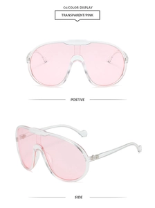 Detailed view of oversized pink transparent shield sunglasses with retro pilot frames