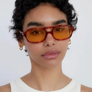 Close-up of retro square amber sunglasses with double bridge frame on fashion model