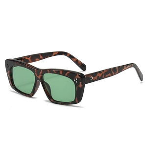 Retro tortoiseshell cat eye sunglasses with green lenses and silver rivet accents