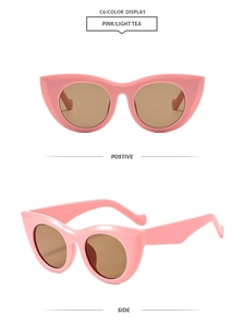 Macro shot of retro cat-eye sunglasses with pink frames and light tea-colored lenses