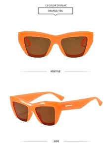 Detail view of orange cat eye sunglasses with tea lenses and golden metal accents