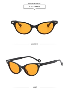 Detail of black cat-eye sunglasses with orange lenses and metal B logo on the temple