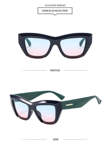 Detail of dark blue cat eye sunglasses with blue pink gradient lens and gold metal trim