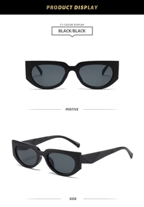 Detail view of black cat-eye sunglasses with geometric sculpted temples and dark lenses