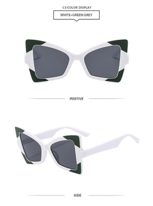 Detail of white butterfly sunglasses with green corner accents and grey lenses