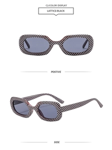 Detail view of square sunglasses with black and white checkerboard pattern and dark grey lenses