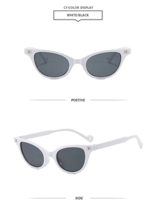 Detail of white cat-eye sunglasses featuring metallic letter B on the side temple