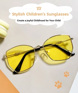 Close-up of golden metal frame children's sunglasses with yellow hexagonal lenses