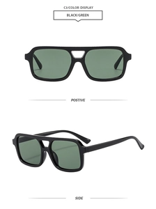 Detail view of square black frame sunglasses with green lenses and double bridge design