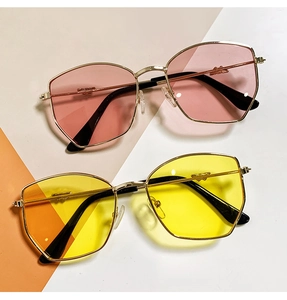 Close-up of geometric polygon metal frames with pink and yellow translucent lenses