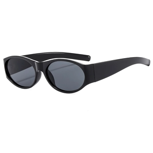 Retro oval black frame sunglasses with dark grey lenses and a minimalist street style