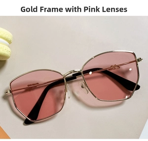Detail of children's hexagonal gold metal sunglasses with translucent pink lenses