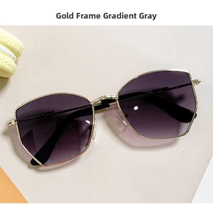 Detail of children sunglasses with golden metal frames and gradient grey lenses