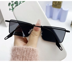 Detail of slim black metal frame rectangle sunglasses with dark polarized lenses