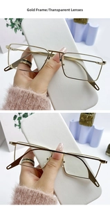 Macro view of rectangle gold metal frame glasses with transparent lenses and nose pads